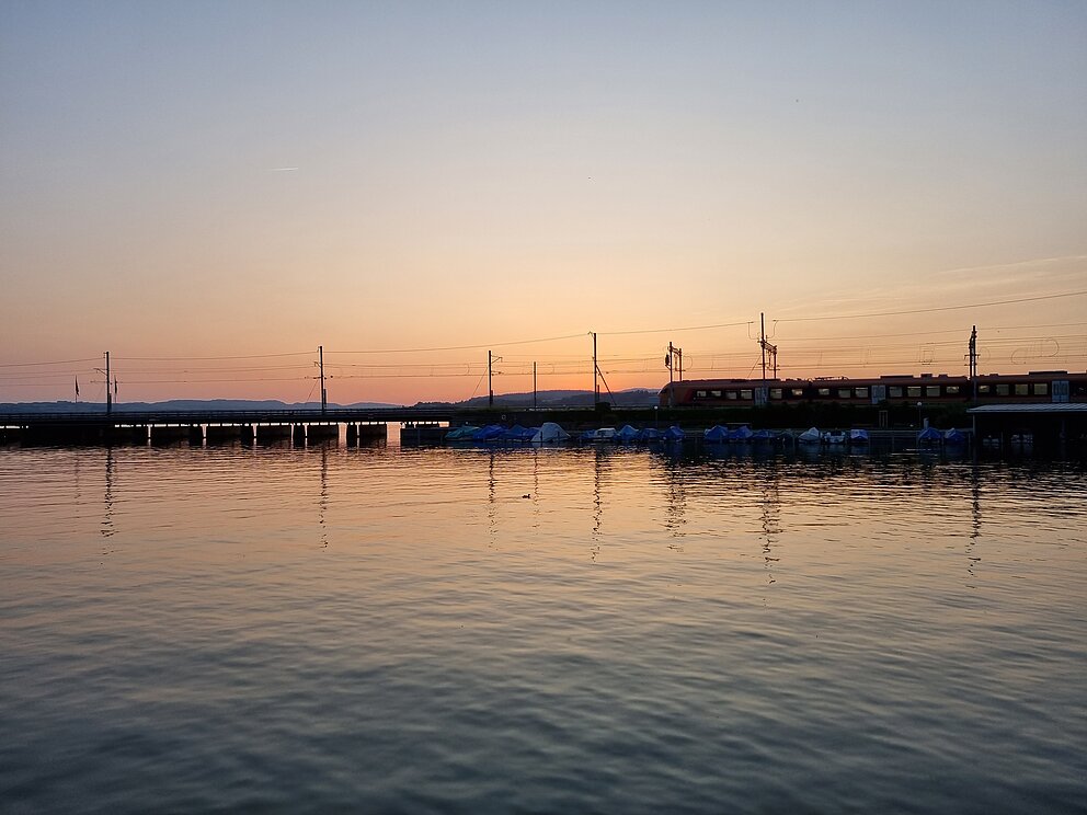 Das drittplatzierte Bild zeigt den Traverso auf dem Seedamm bei Sonnenuntergang.
